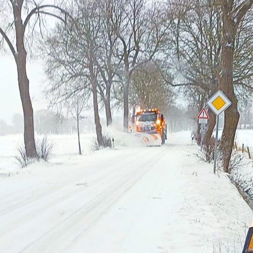 Winterdienst-Fahrzeug von Manfred Ende im Einsatz auf verschneiter Straße in Westerstede. Leistungen für Kommunen